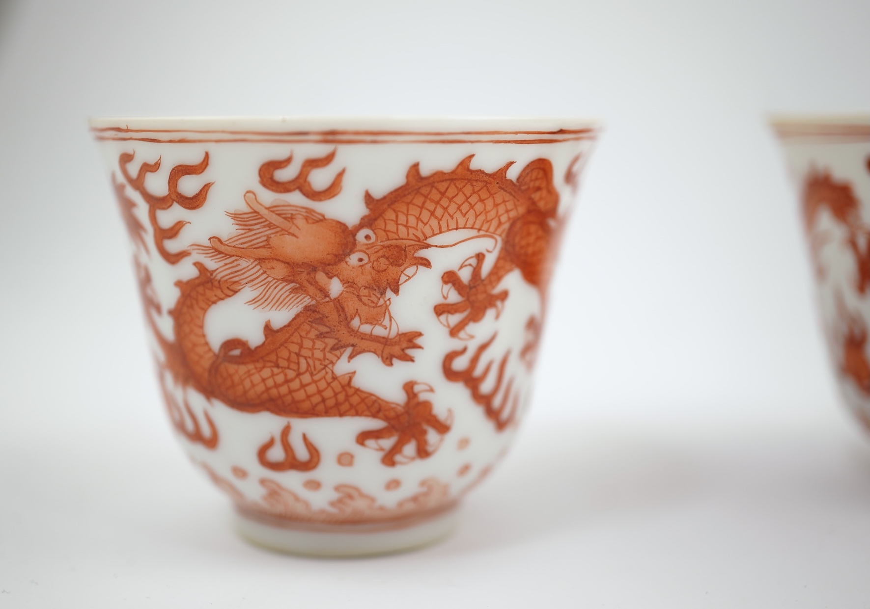 A pair of Chinese iron red ‘dragon’ cups, Guangxu six character mark and probably of the period (1875-1908)